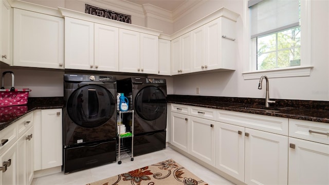 washroom featuring separate washer and dryer, cabinets, sink, ornamental molding, and light tile patterned flooring