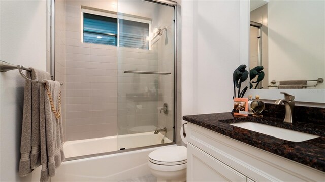 9260 Swaying Branch Rd, Sarasota, FL 34241 - full bathroom featuring vanity, toilet, and combined bath / shower with glass door