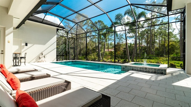 view of swimming pool featuring a lanai, an in ground hot tub, and a patio area