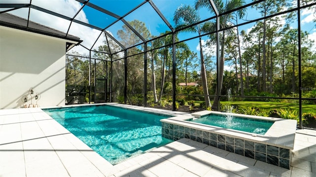 view of pool with glass enclosure, a patio, and an in ground hot tub