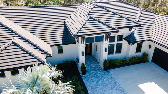 9260 Swaying Branch Rd, Sarasota, FL 34241 - view of front of house featuring a tile roof and a patio