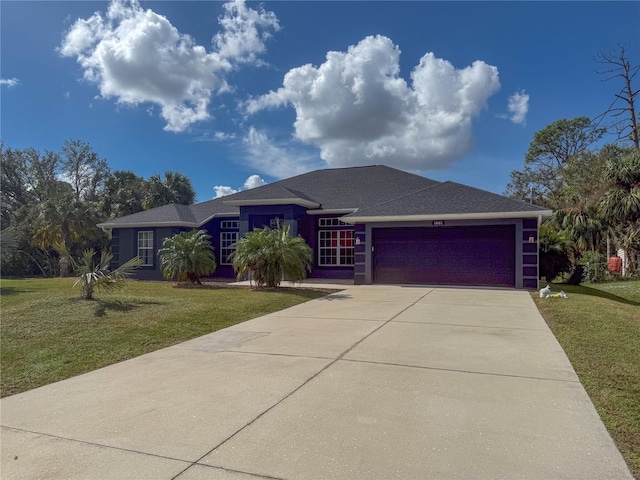 1661 Atwater Dr, North Port, FL 34288 - view of front of house featuring a garage, driveway, a front lawn, and a shingled roof