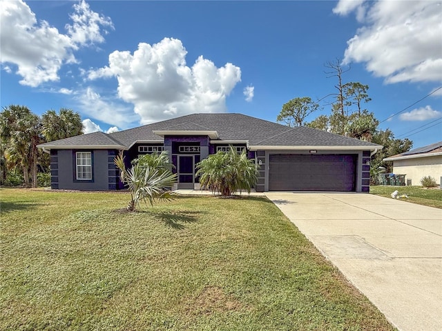 view of front of property featuring a front lawn and a garage