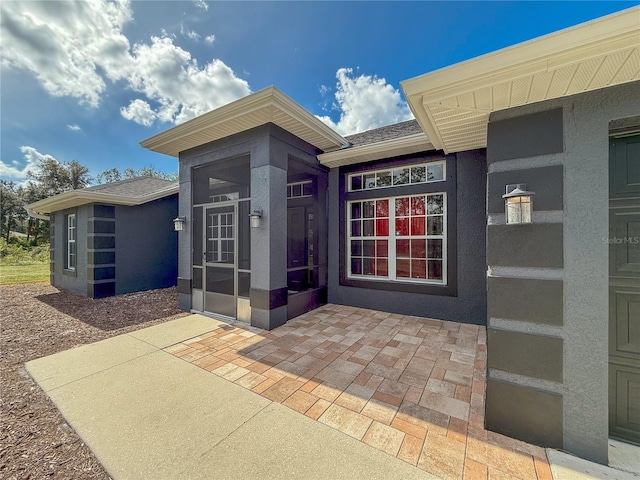 entrance to property featuring a patio