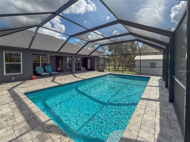 view of swimming pool with a lanai and a patio area