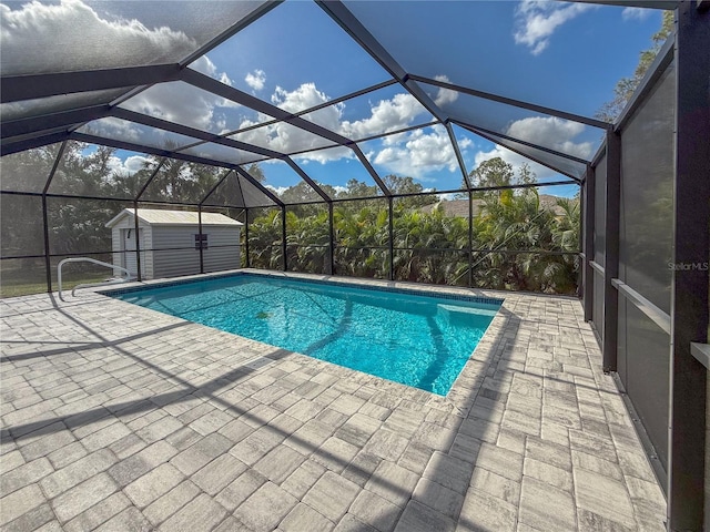 view of pool with a storage shed, glass enclosure, and a patio