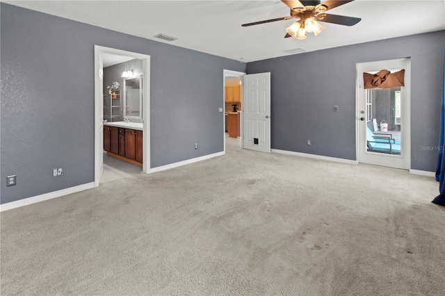 spare room featuring light carpet and ceiling fan