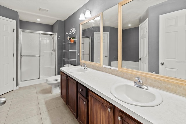 bathroom with tile patterned flooring, an enclosed shower, vanity, and toilet