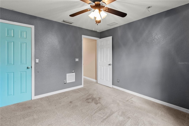 unfurnished room featuring light colored carpet and ceiling fan