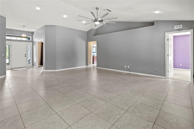 tiled spare room with vaulted ceiling and ceiling fan