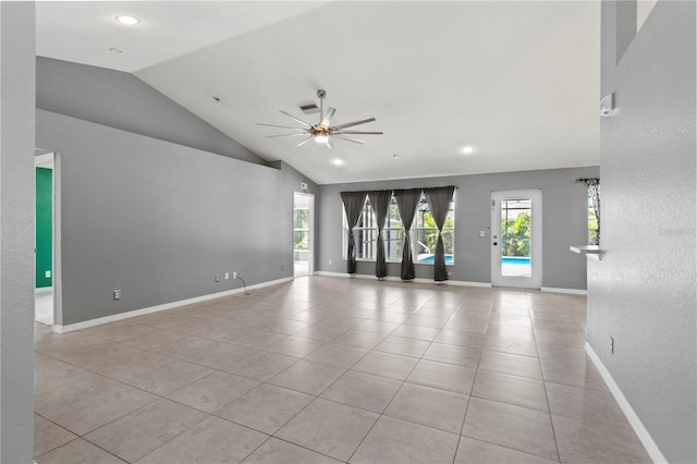 tiled empty room featuring lofted ceiling and ceiling fan