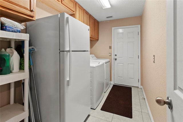 laundry room featuring cabinets and light tile patterned floors