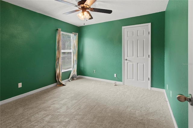 empty room featuring carpet flooring and ceiling fan