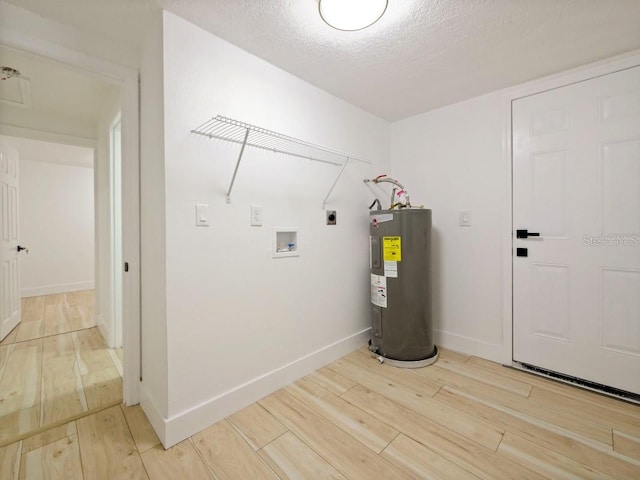 washroom with a textured ceiling, hardwood / wood-style flooring, hookup for a washing machine, water heater, and hookup for an electric dryer