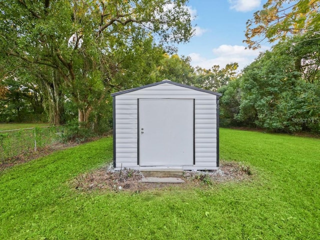 view of outbuilding with a yard