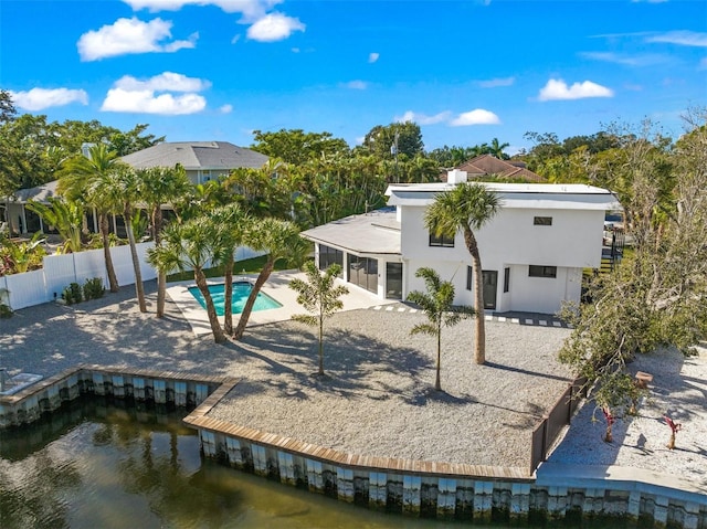 4915 Primrose Path, Sarasota, FL 34242 - rear view of property with stucco siding, a water view, fence, and a patio area