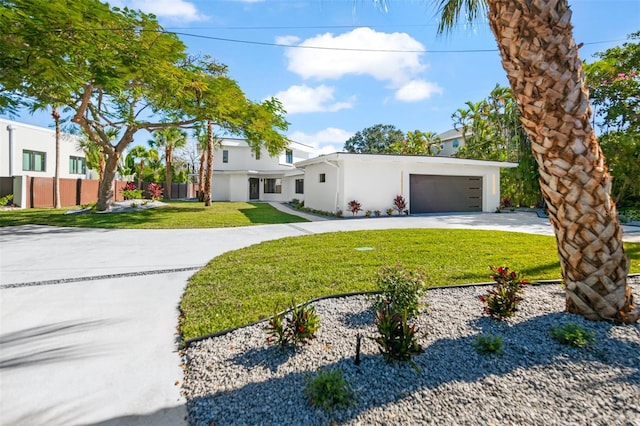 view of front facade with a garage and a front lawn