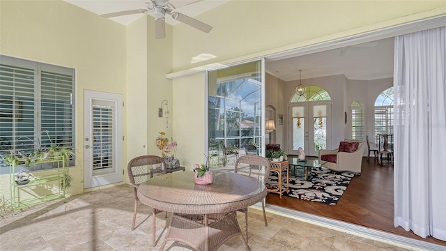 sunroom featuring french doors and ceiling fan