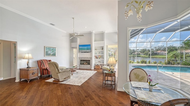 living room featuring dark wood-type flooring, ceiling fan, and a high ceiling