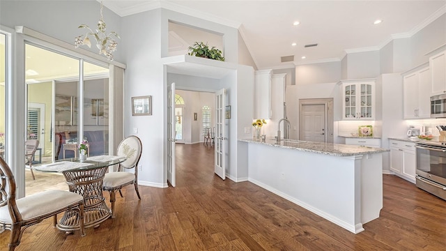 kitchen featuring white cabinetry, appliances with stainless steel finishes, and dark hardwood / wood-style flooring