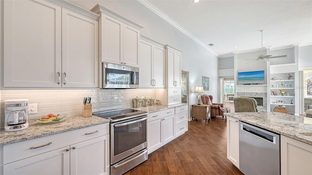 kitchen featuring white cabinetry, appliances with stainless steel finishes, dark wood-type flooring, and ornamental molding