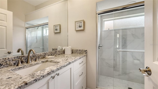 bathroom with vanity and a shower with shower door