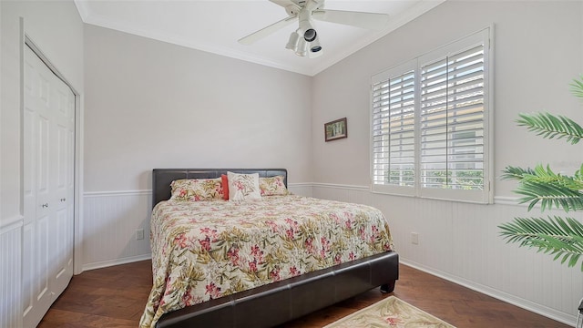 bedroom featuring a closet, multiple windows, ceiling fan, and dark hardwood / wood-style floors