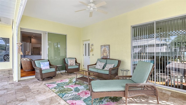 sunroom / solarium featuring ceiling fan