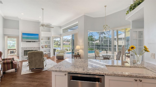 kitchen with white cabinets, light stone countertops, dark hardwood / wood-style floors, and hanging light fixtures