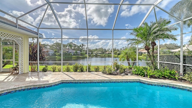 view of swimming pool with a lanai, a water view, and a patio area