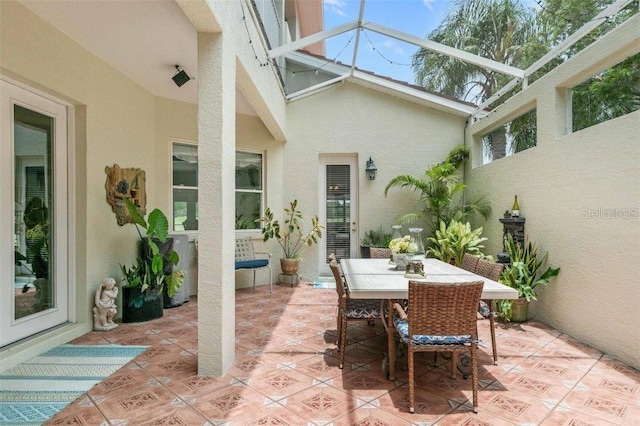 4561 Murcia Blvd Unit 13, Sarasota, FL 34238 - view of patio / terrace featuring outdoor dining area and glass enclosure