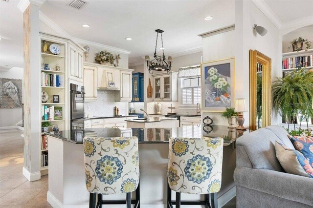 4561 Murcia Blvd Unit 13, Sarasota, FL 34238 - kitchen with crown molding, open shelves, wall chimney exhaust hood, tasteful backsplash, and a sink