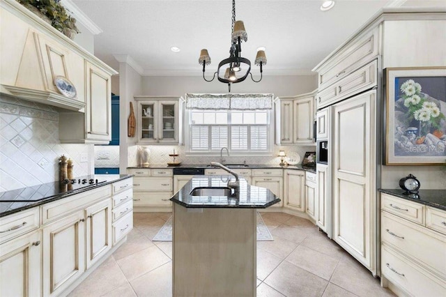 4561 Murcia Blvd Unit 13, Sarasota, FL 34238 - kitchen with ornamental molding, cream cabinets, a chandelier, a kitchen island with sink, and backsplash
