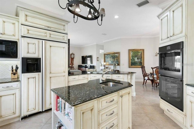 4561 Murcia Blvd Unit 13, Sarasota, FL 34238 - kitchen featuring black appliances, cream cabinetry, a sink, light tile patterned floors, and a chandelier