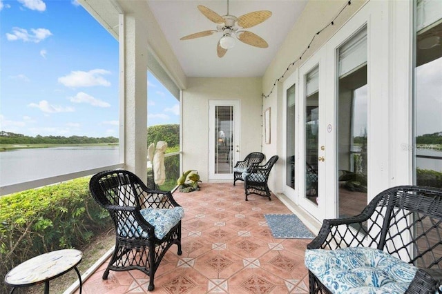 4561 Murcia Blvd Unit 13, Sarasota, FL 34238 - sunroom / solarium featuring french doors, ceiling fan, tile patterned floors, and a water view