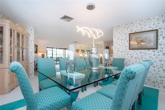 dining room with carpet and an inviting chandelier