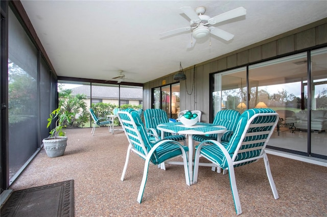 sunroom / solarium featuring ceiling fan