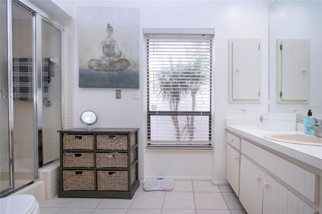 full bathroom featuring toilet, combined bath / shower with glass door, vanity, and tile patterned flooring