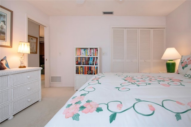 bedroom with a closet and light carpet