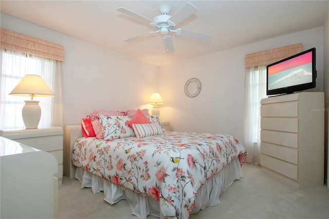 bedroom featuring ceiling fan and light carpet