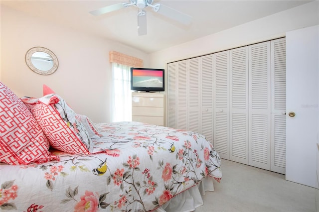 carpeted bedroom featuring ceiling fan and a closet