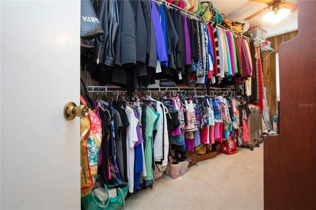 spacious closet with ceiling fan and carpet flooring