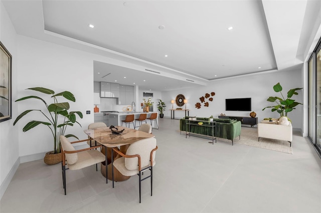 dining area with a tray ceiling