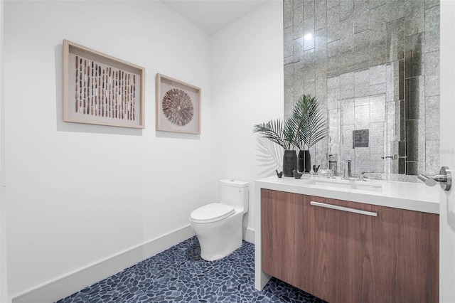 bathroom featuring toilet, vanity, and tile patterned floors