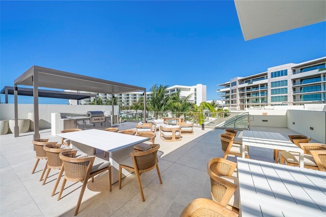 view of patio / terrace featuring area for grilling and a balcony