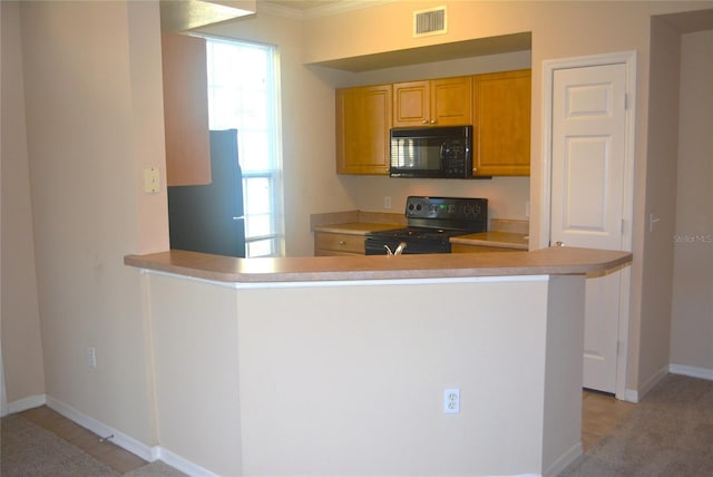 kitchen with black appliances, kitchen peninsula, and ornamental molding