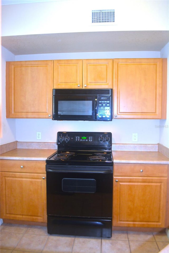 kitchen with light tile patterned floors and black appliances