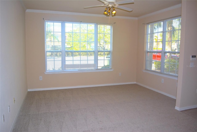 empty room featuring light colored carpet, ceiling fan, and crown molding