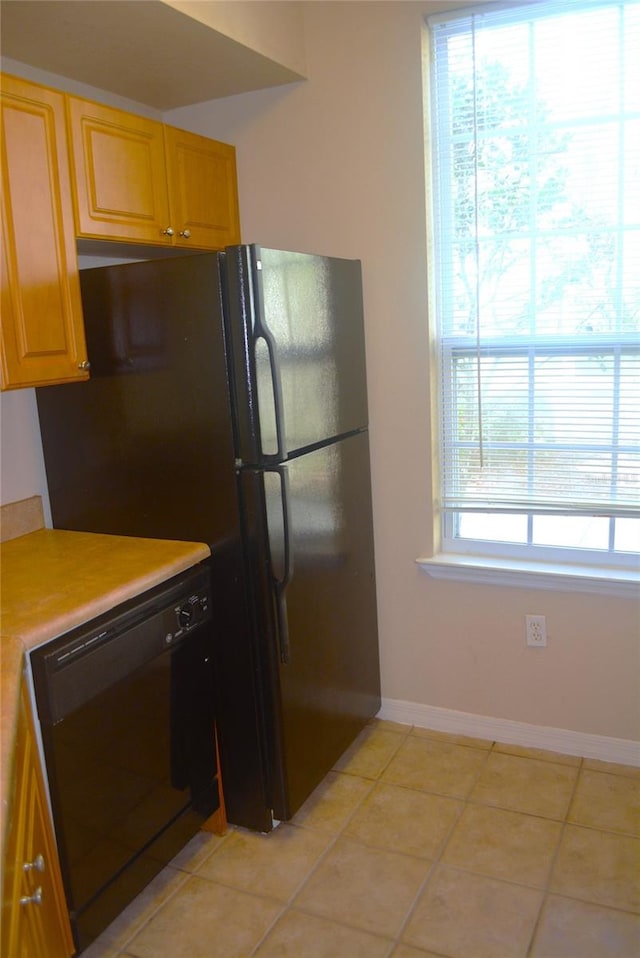 kitchen featuring black appliances and light tile patterned flooring