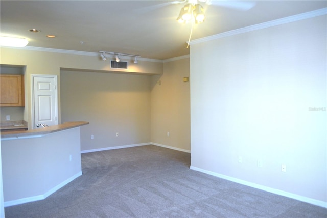 unfurnished living room with dark colored carpet, ceiling fan, and crown molding